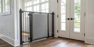 A safe and stylish Crypton fabric pet gate with a metal frame in a modern entryway.